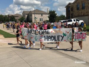 Initial banner during the parade for the Sunshine Spaces reveal. (Photo from The Creek Yearbook.)