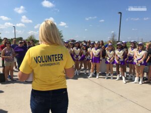 A volunteer talks to TCHS students before the Sunshine Spaces reveal. (Photo from The Creek Yearbook.)